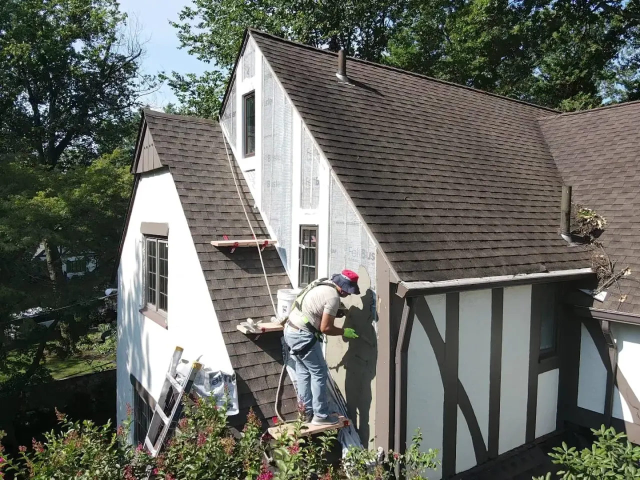 Crew finishing a shingle roof